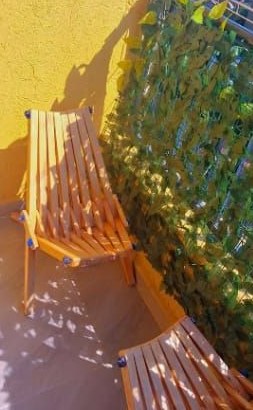 Private balcony with wooden seats at The Praxing Nest BnB in Kakamega